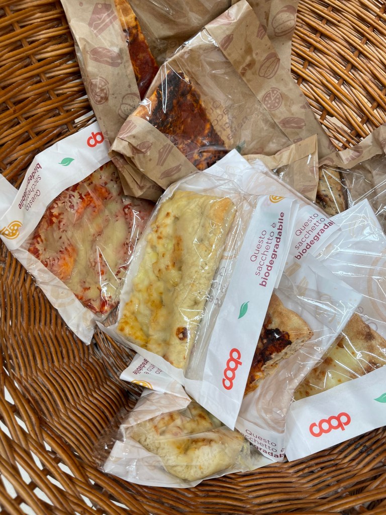 To-Go pizzas in a bag at Coop grocery store in Siena, Italy