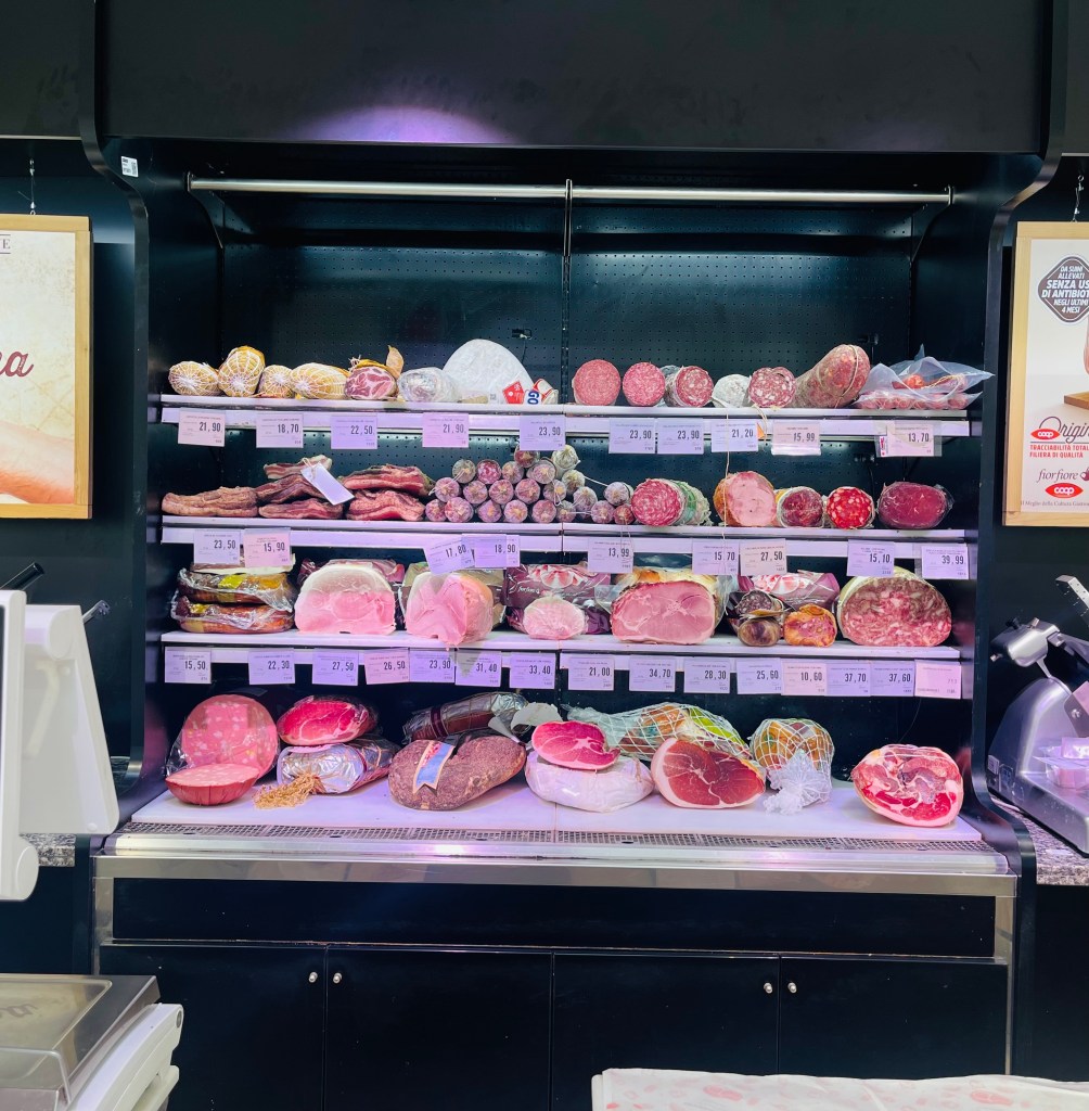 Cured meats cooler at Coop grocery store in Siena, Italy