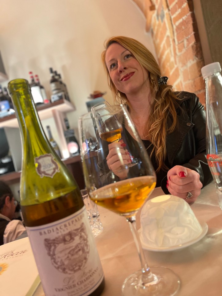 Katie with her glass of orange wine at Podera la Rocca Agriturismo in Montepulciano, Italy