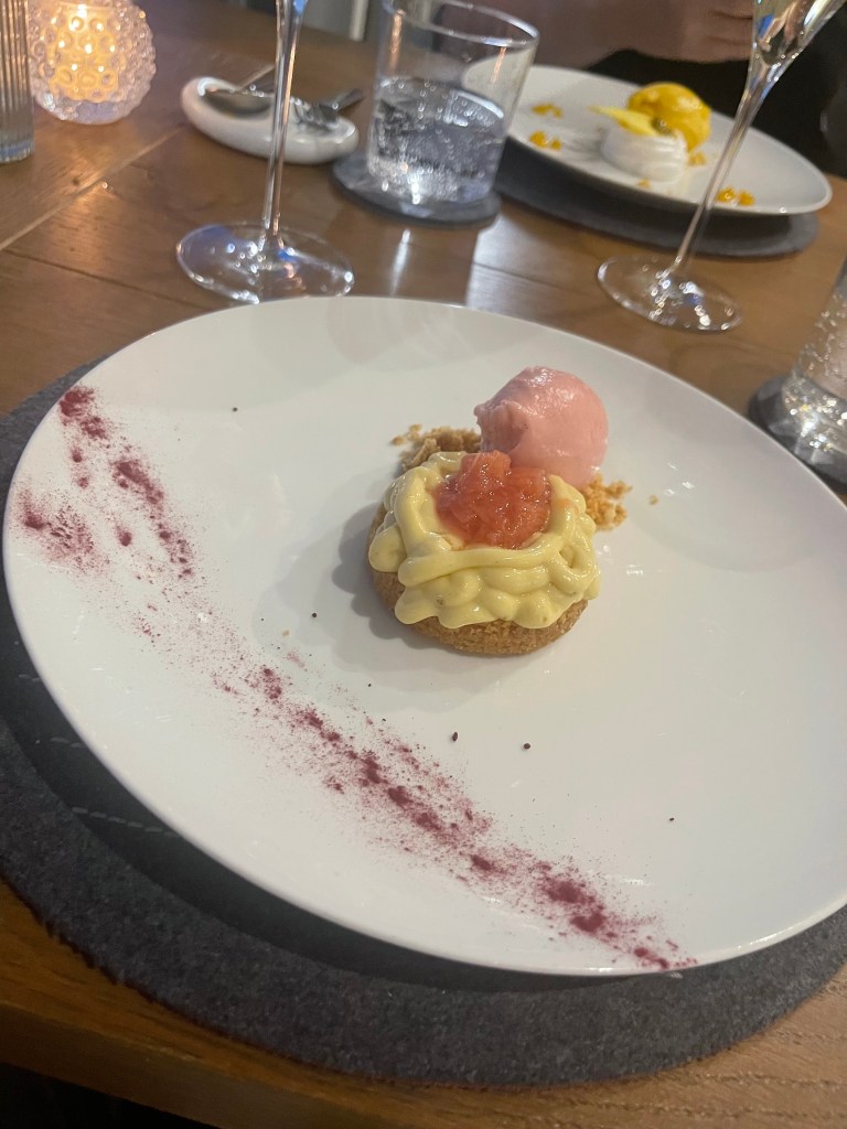 Almond Cookies Served with Rhubarb, Passion Fruit and Mango Pavlova