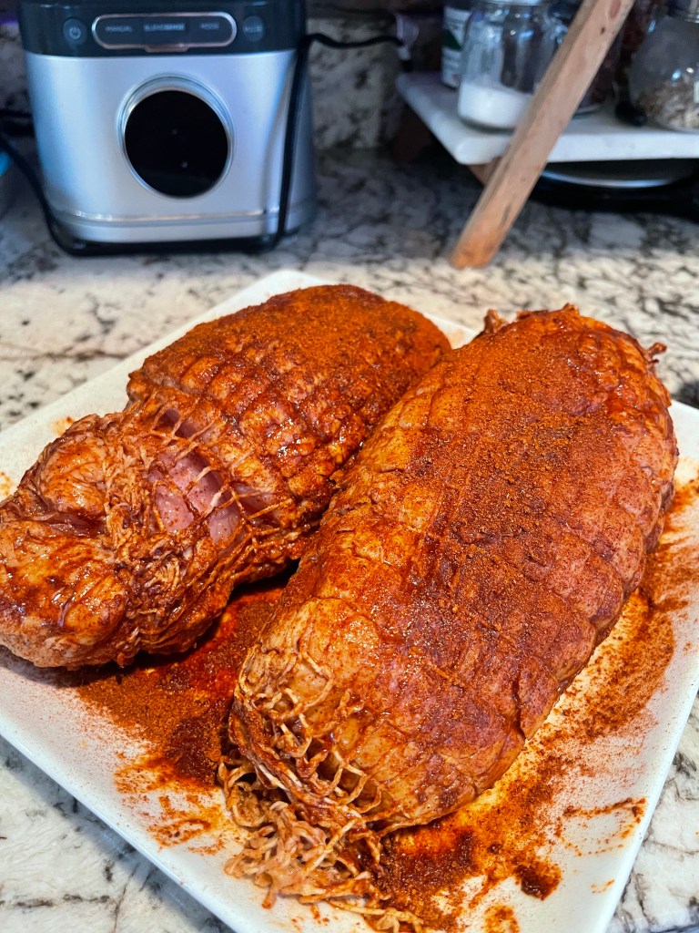 Turkey breasts out of the brine, seasoned and ready for the smoker.
