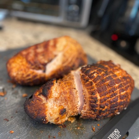 Smoked Thanksgiving turkey breasts ready to be sliced.