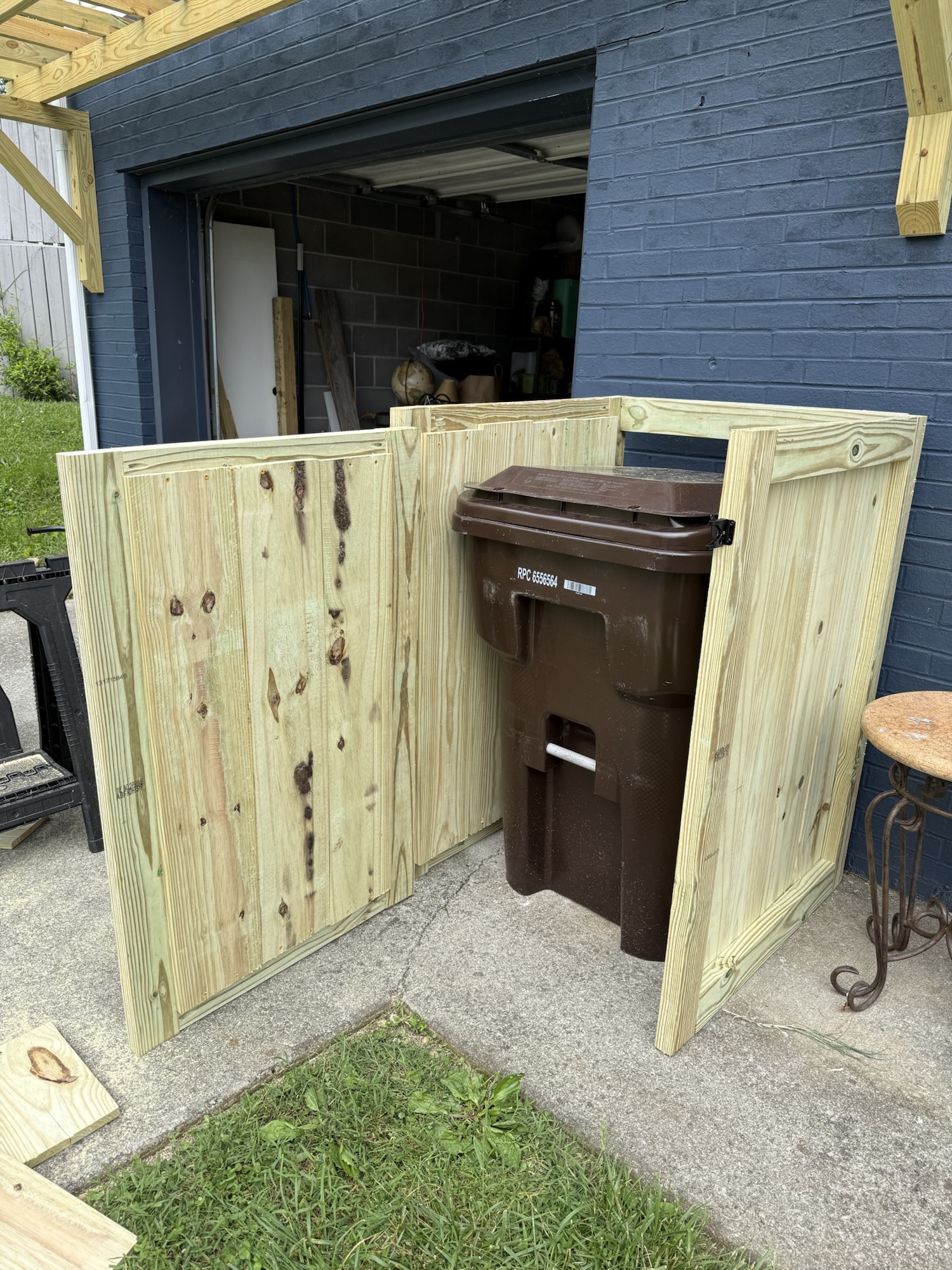 Completed trash can screen, door open.